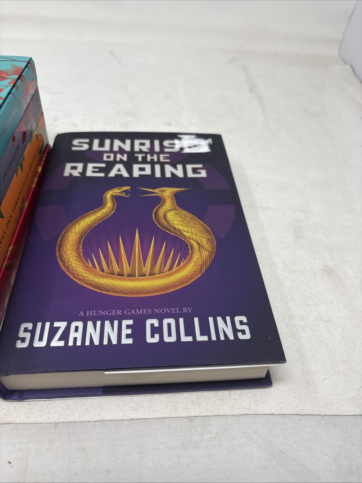 The Deluxe Hunger Games collection paperback + hard cover sunrise on the reaping