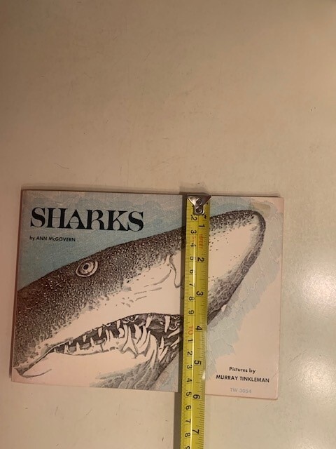 Sharks book by Ann McGovern. 47 pages. Scholastic Book services. Copyright 1976